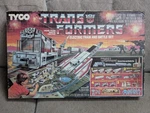 1985 Tyco Electric Train G1 Transformers Battle Set Sealed Box. Fixed Price $700.00.